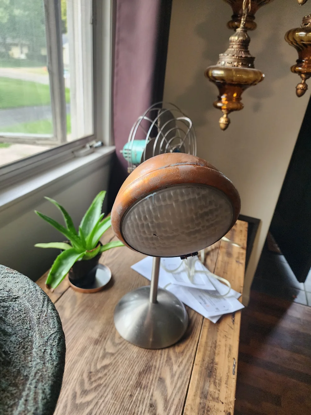 Antique car bucket light repurposed into a table lamp.